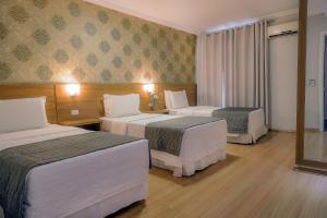 Postel nebo postele na pokoji v ubytování Hotel Rafain Centro