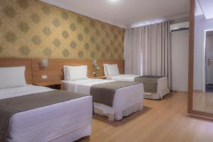 Postel nebo postele na pokoji v ubytování Hotel Rafain Centro