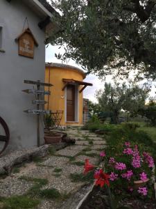 una casa con un cartel y flores delante de ella en C'era una volta Podere San Giovanni, en Fossacesia