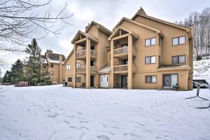 a large apartment building in the snow at Ski-In and Out and Golf Condo with A and C at Holiday Valley! in Ellicottville