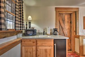 eine Küche mit einer Spüle und einer Mikrowelle in der Unterkunft Berkeley Springs Haven with Sleepy Creek Access! in Berkeley Springs