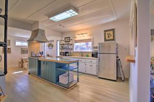a large kitchen with a refrigerator and a counter top at Texas Home with Backyard Oasis, Walk to Main St in Fredericksburg +17 photos