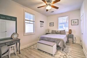 a bedroom with a bed and a desk and a ceiling fan at Texas Home with Backyard Oasis, Walk to Main St in Fredericksburg