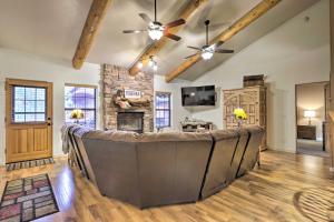 eine große Couch in einem Wohnzimmer mit einem Steinkamin in der Unterkunft Furnished Balcony with Fire Pit Pinetop Mtn Escape! in Indian Pine