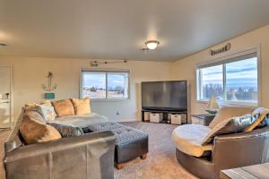 a living room with two couches and a flat screen tv at Lake McConaughy Getaway with Covered Patio in Belmar