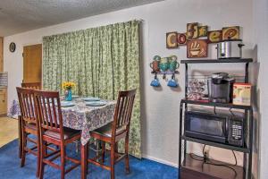 a dining room with a table and chairs and a microwave at Dog-Friendly Bartlesville Retreat with Yard! in Bartlesville
