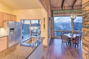 a kitchen and dining room with a table with chairs at Brevard Home with Panoramic Lake and Mountain Views! in Brevard