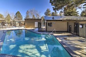 a swimming pool in front of a house at Mammoth Lakes Condo with Pool Less Than 5 Mi to Skiing! in Mammoth Lakes