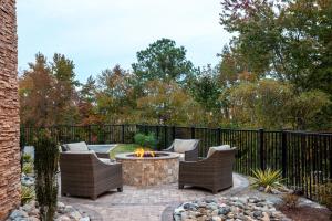 a patio with two chairs and a fire pit at Staybridge Suites Chesapeake-Virginia Beach, an IHG Hotel in Chesapeake