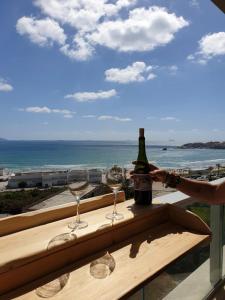 a table with wine glasses and a view of the ocean at Acre sea view 11th floor apartment in ‘Akko