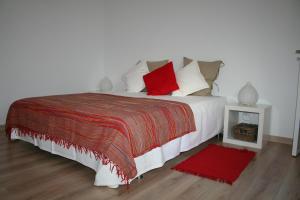 a bedroom with a large white bed with red pillows at Apartment Portimao Old Town in Portimão
