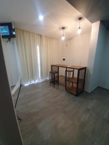 a room with a table and chairs and a television at BLU APARTMENTS in San Rafael