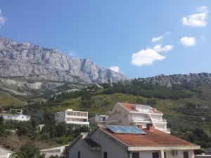a house with solar panels on a mountain at Apartments Stakic in Krvavica