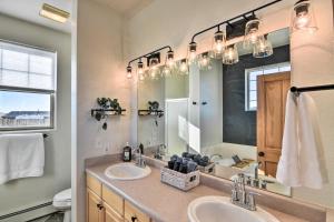 a bathroom with two sinks and a large mirror at 503 Mountain Loft with Views 1 Mi to Dwtn Fairplay! in Fairplay +25 photos