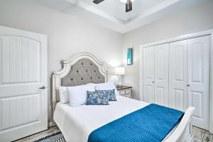 a white bedroom with a bed with a blue blanket at Chic Edinburg Escape Hike, Fish, and Explore! in Edinburg