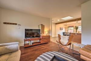 a living room with a couch and a tv at Renovated Home with Private Yard Near Austin Hotspots in Austin