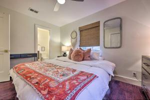 a bedroom with a large bed and a mirror at 6 Mi to Dtwn Austin Home with Screened Porch and Yard in Austin