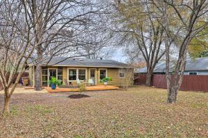 a small yellow house with a porch in a yard at Renovated Home with Private Yard Near Austin Hotspots in Austin