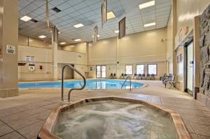 a hot tub in a large room with a swimming pool at Beech Mtn Condo w/ Slope View & Resort-Style Perks in Beech Mountain