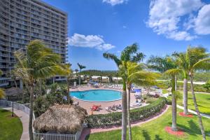 a view of the pool at a resort with palm trees at Cozy Coastal Condo with Pool Access Steps to Beach! in Marco Island