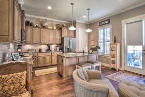 a large kitchen with wooden cabinets and a kitchen island at Pet-Friendly Townhome about 2 Mi to Town Square! in Georgetown