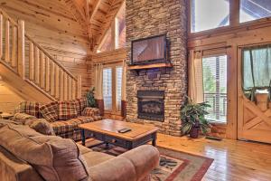a living room with a couch and a fireplace at Pigeon Forge Cabin with Games, 1 Mi to Parkway! in Pigeon Forge