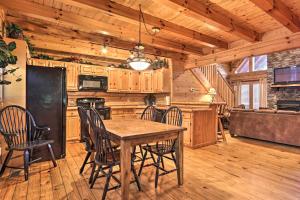 a kitchen with a table and chairs in a cabin at Pigeon Forge Cabin with Games, 1 Mi to Parkway! in Pigeon Forge