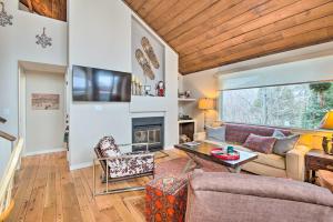a living room with a couch and a fireplace at Chic Village of Loon Getaway Less Than 1 Mi to Ski Slopes! in Lincoln