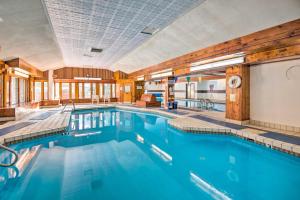 a swimming pool with blue water in a building at Chic Village of Loon Getaway Less Than 1 Mi to Ski Slopes! in Lincoln
