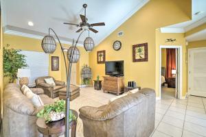 a living room with couches and a flat screen tv at Coastal Condo with Pool in South Padre Island! in South Padre Island
