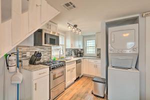 a kitchen with white cabinets and a stove top oven at Modern Townhome Walk to Beach, Bars and Eats! in Seaside Heights