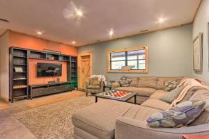 a living room with a couch and a tv at Pet-Friendly Blue Ridge, Cherokee Forest Retreat! in Greeneville