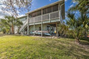 an exterior view of a house with a large porch at Serene Hudson Home on Canal with Direct Gulf Access in Hudson