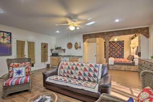 a living room with a couch and a ceiling fan at Cozy and Quiet Studio with Porch, Near Scenic Railway! in Blue Ridge