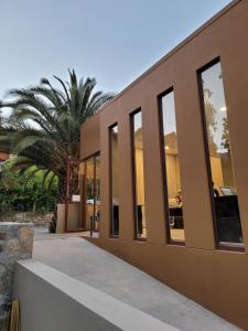 a building with large windows and a palm tree at Hotel El Tesoro de Elqui in Pisco Elqui