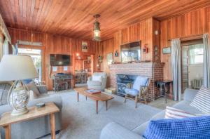 a living room filled with furniture and a fireplace at Byers Boathouse on the Prom - Meredith Lodging in Seaside