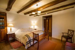 A bed or beds in a room at Hacienda San Agustin de Callo
