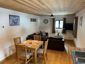a living room with a table and a couch at Just Morzine - Apartment Luna in Morzine