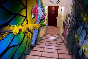 a hallway with a painting on the wall at Passion Hostel - Barranco in Lima