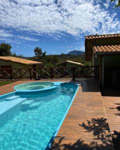a large swimming pool in a yard with a house at Pousada Lapralapa in Santana do Riacho