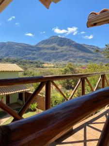 a wooden railing with a view of a mountain at Pousada Lapralapa in Santana do Riacho