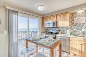 a kitchen with a table and a view of the ocean at Whale Watcher Condo #3 in Rockaway Beach