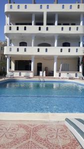 a large swimming pool in front of a building at Nile View Hotel in Luxor