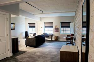 a living room with a couch and a table at Hotel Millwright in Amana