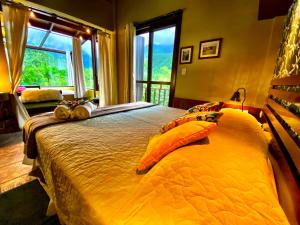 a bedroom with a large bed with pillows on it at Refúgio Ecológico Pedra Afiada in Praia Grande +250 photos
