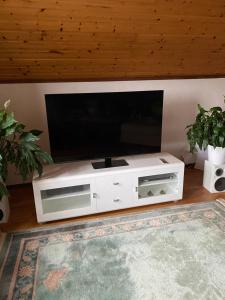 a white entertainment center with a flat screen tv at Anitas B&B Stockholm/Vällingby in Stockholm