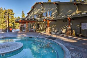 a swimming pool in front of a house with a building at Ski-InandSki-Out Northstar Condo Near Lake Tahoe! in Truckee