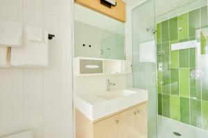 a bathroom with a sink and a mirror at Sonder The Beverley in Toronto