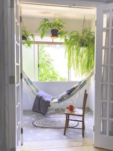 a hammock in a room with a table and a chair at Suite Paulista x Augusta in Sao Paulo