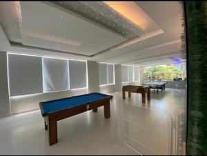 a room with two ping pong tables in it at Flat Sao Vicente in São Vicente